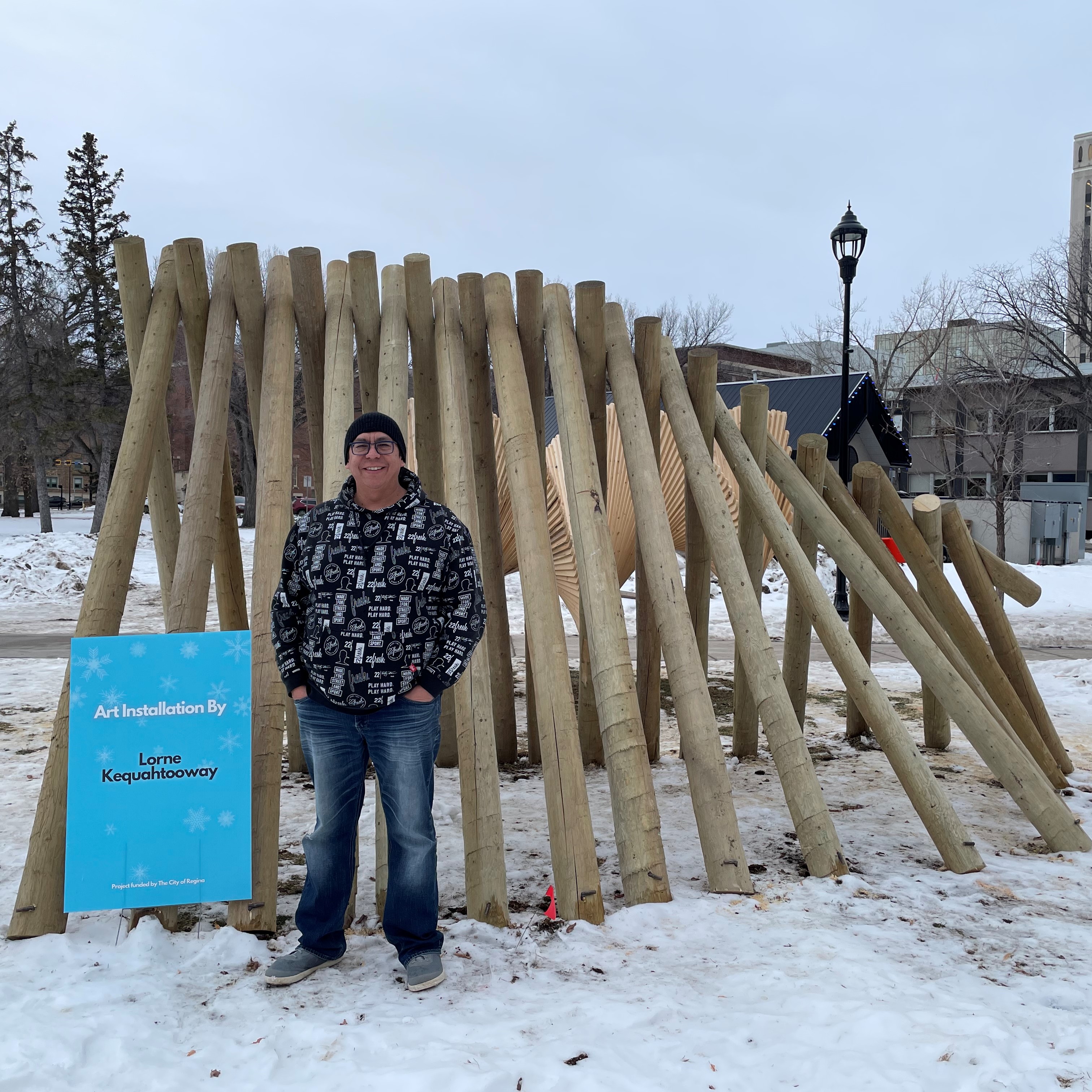 Lorne Kequahtooway standing in form of a sculpture in snow