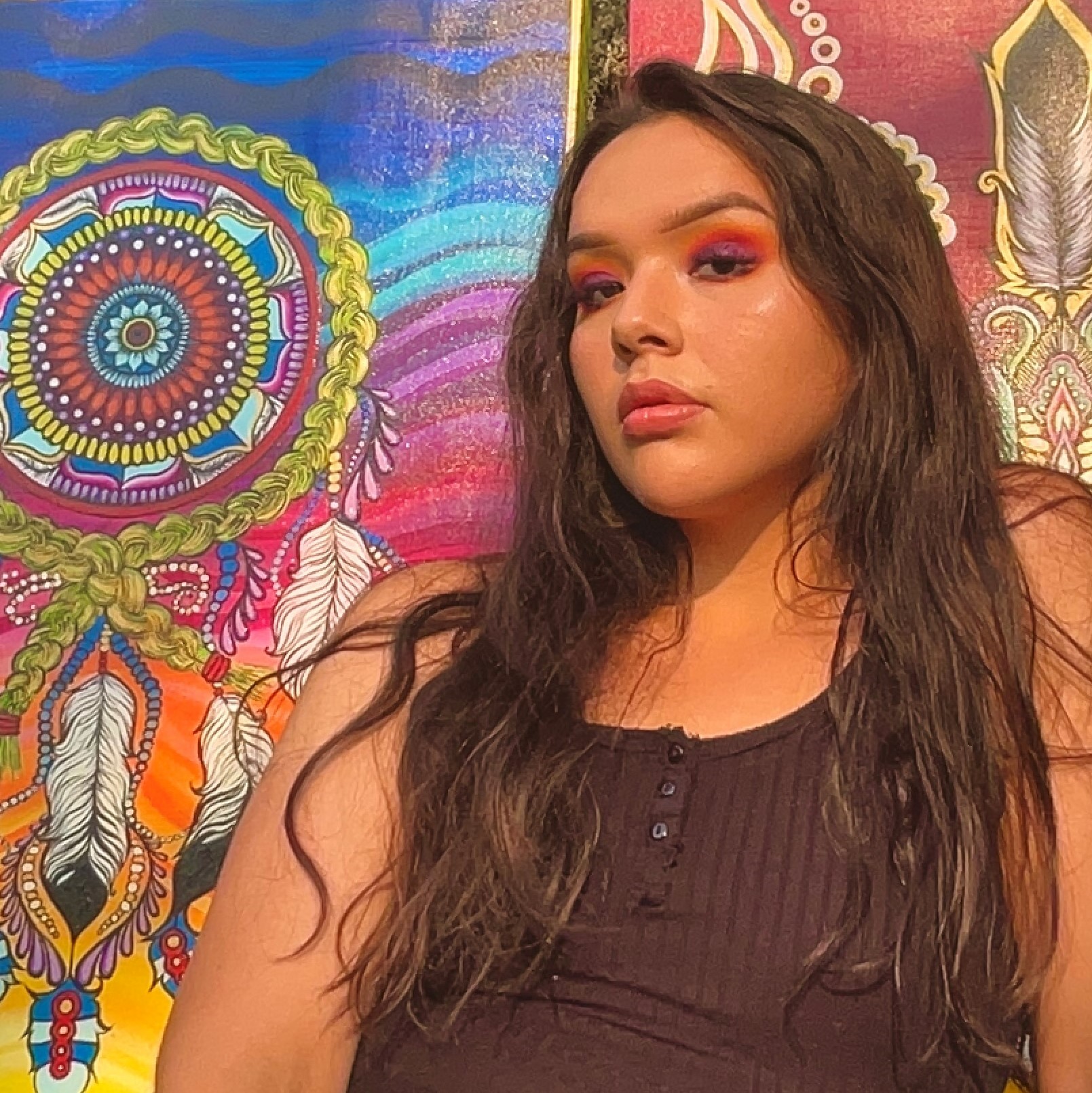 Jayda Delorme - Portrait of young woman with artwork behind her