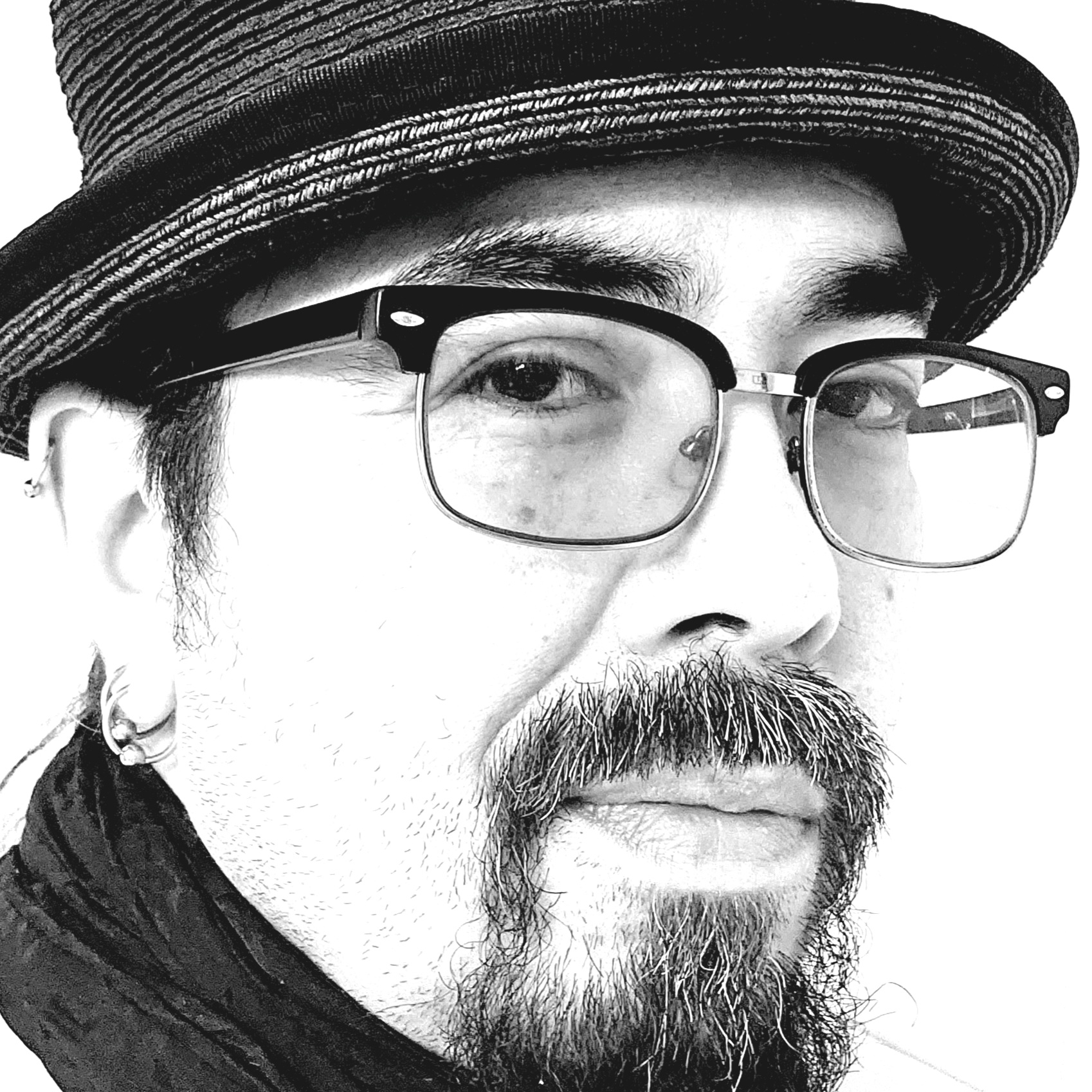 Michael Gamble - Black and white close up portrait of man wearing a hat, and glasses. He has a mustache and goatee.