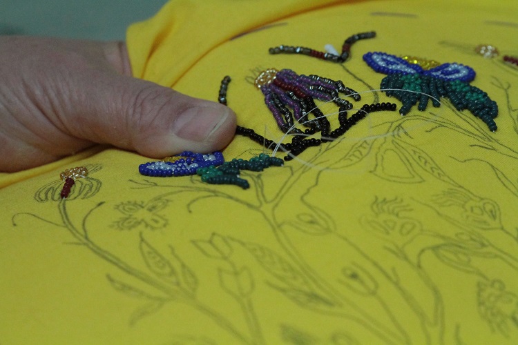 SKArts - Doreen Roman at work on a beaded vamp.