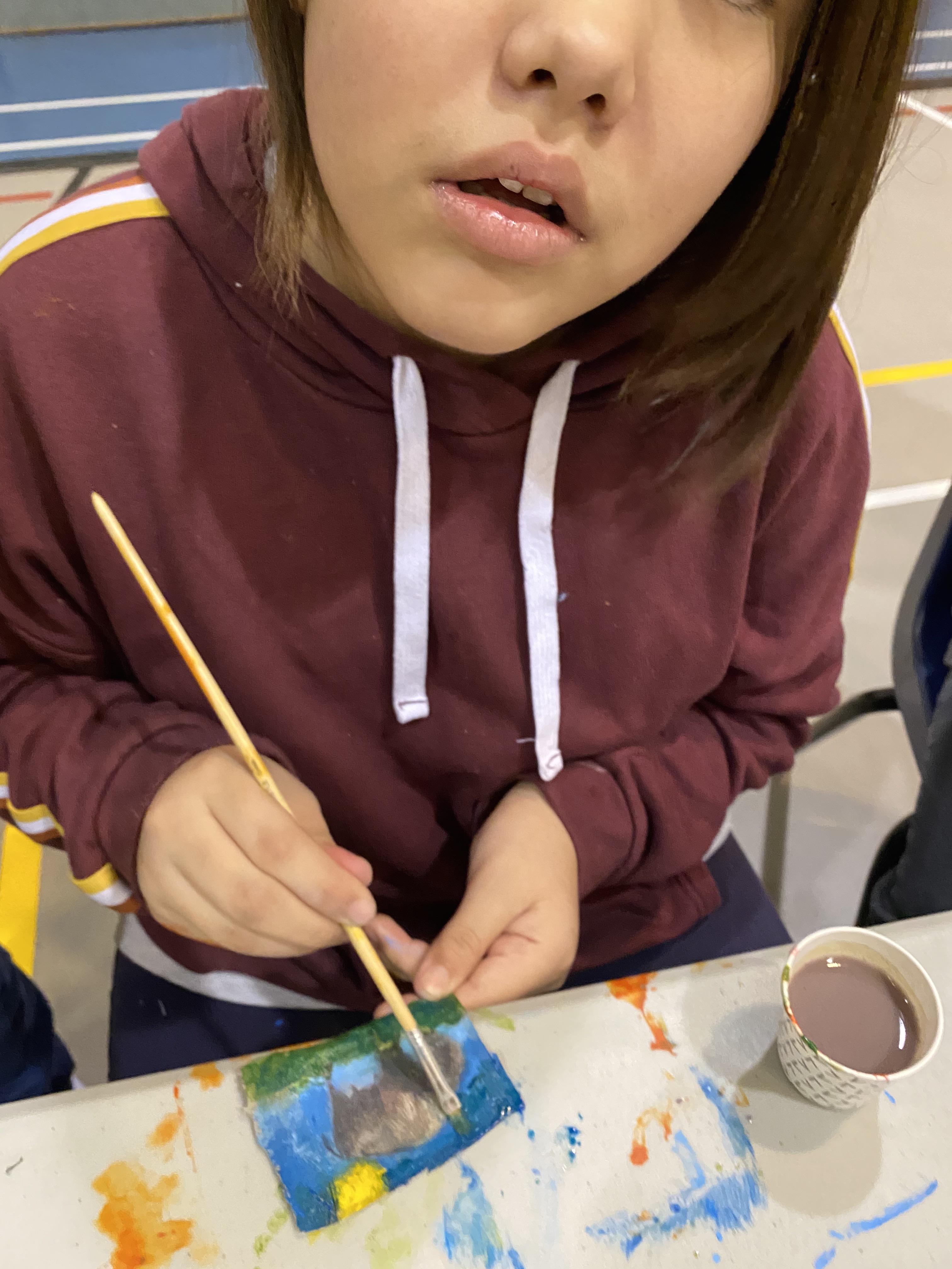 A student paints a picture of a buffalo.