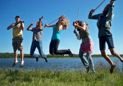 Karrnnel Sawitsky with his class of fiddlers at Kenosee Lake Kitchen Party camp