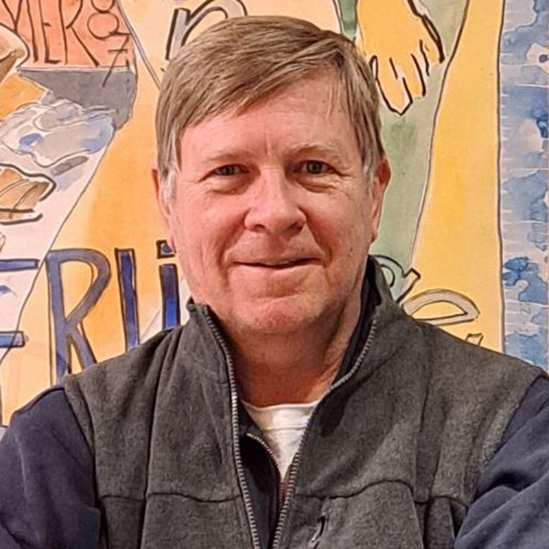 Wayne Baerwaldt - Portrait photo on blond man wearing a gray jacket smiling