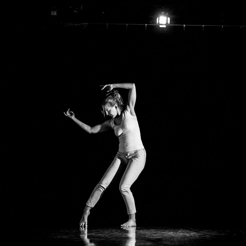 Krista Solheim - Black and white shot of woman dancing with dark background