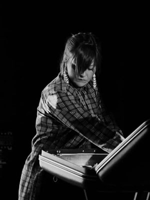 Lenore Maier by Carey Shaw for SK Arts Arts of Celebration 2025. Black and white portrait of woman looking in a suitcase.